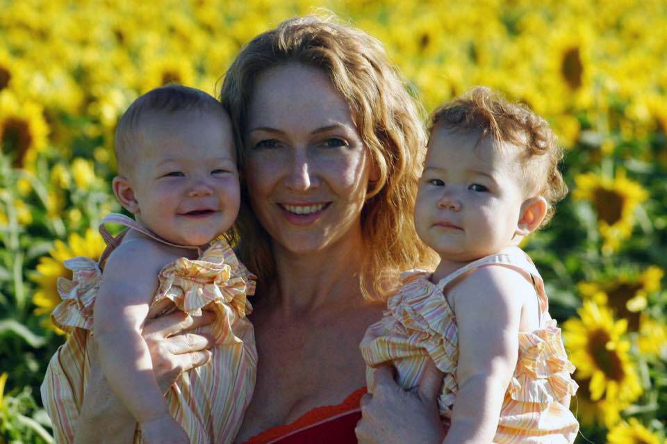 Jean Muggli holding her young daughters.