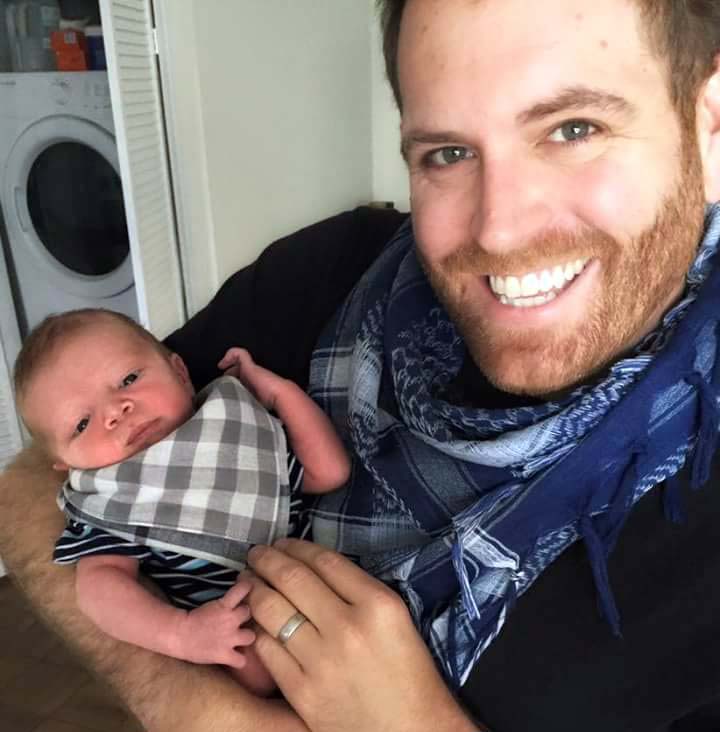 Photo of Hallie Gnatovich's husband holding her son.